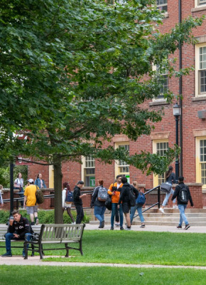 Photo of students walking and entering building on campus